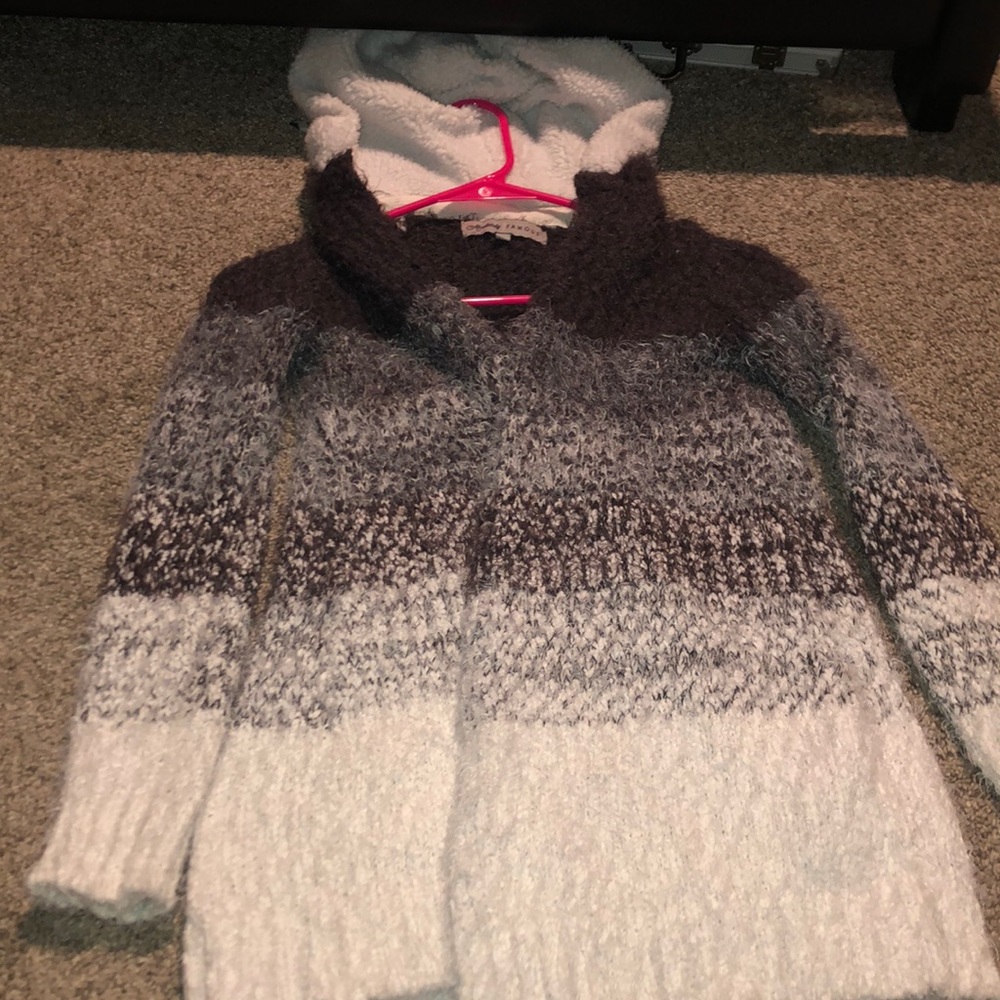 White, grey and black fuzzy cardigan.